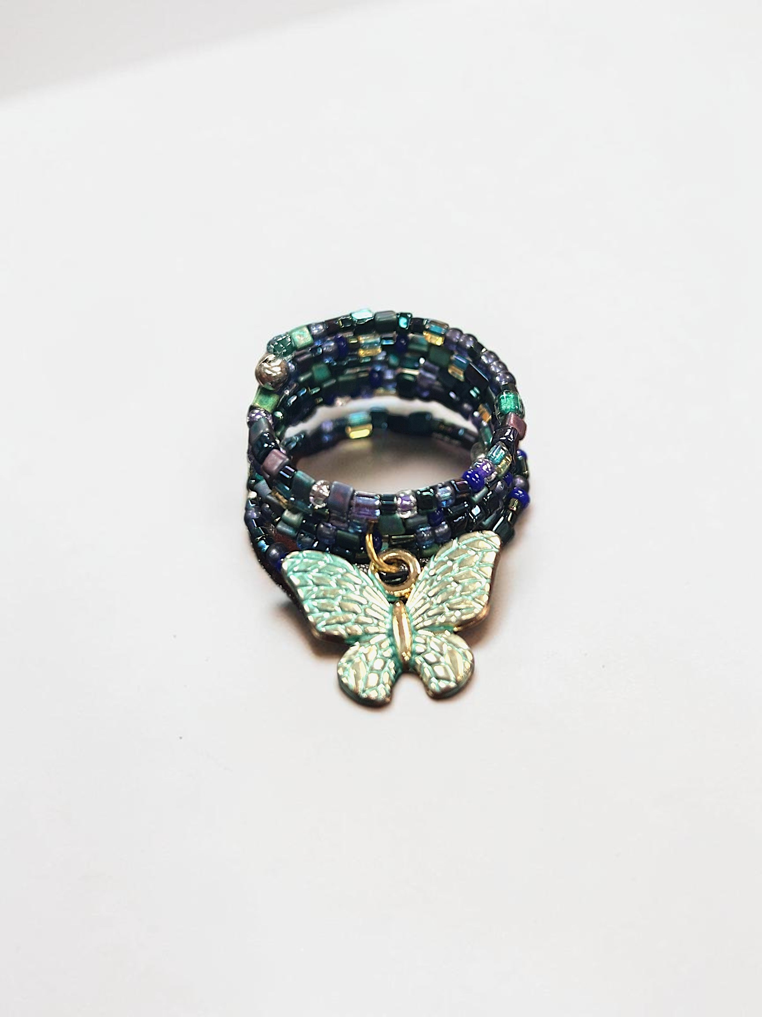 Iridescent Deep Multicolored Beaded Spiral Ring with Aqua Butterfly Charm | Unique Handmade Jewelry
